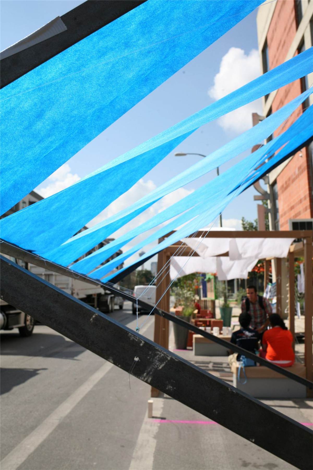 Bus Bench — people testing the shaded bench prototype