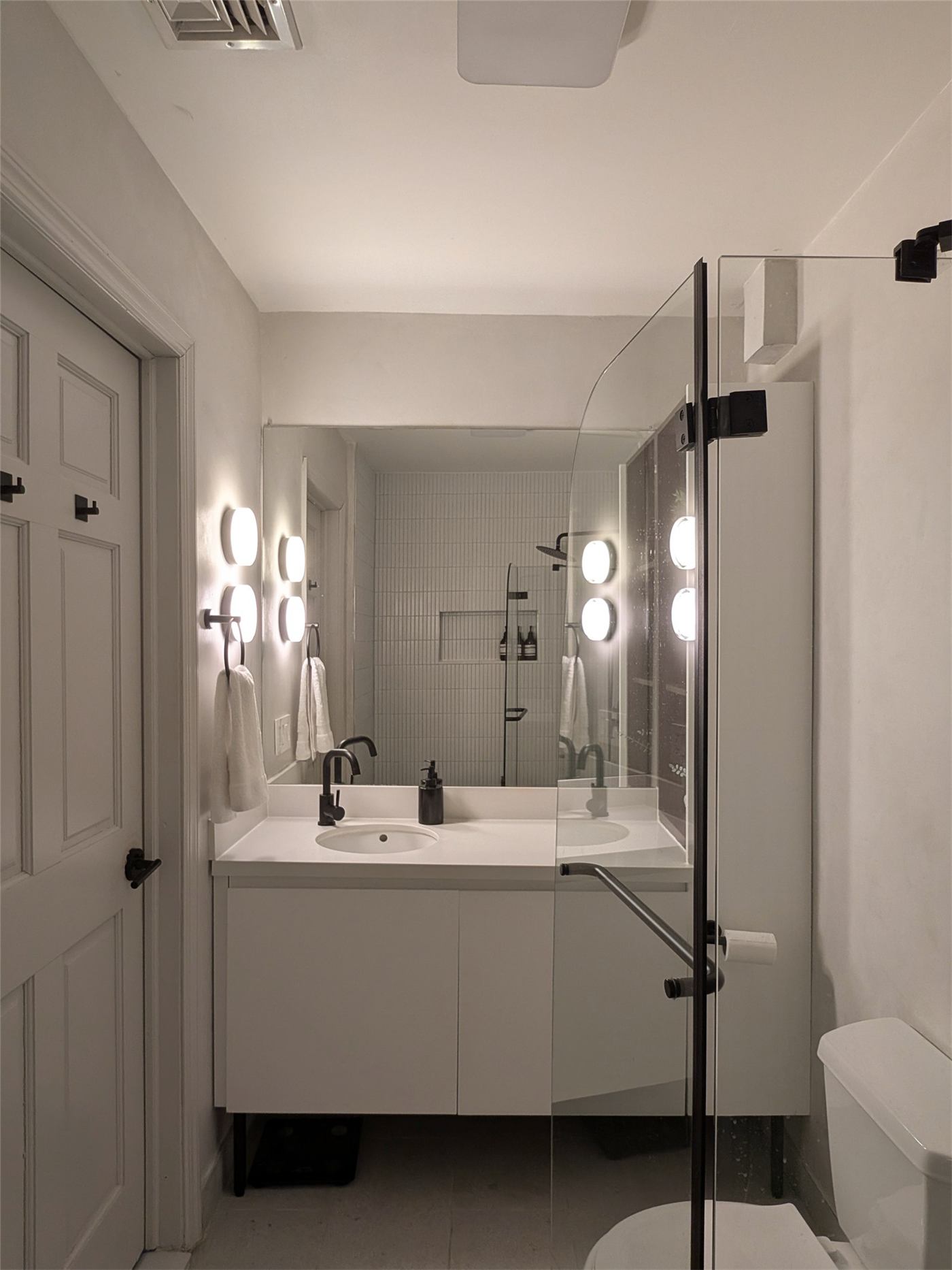 Bathroom No. 1 — contemporary finishes and soft lighting in the compact bath