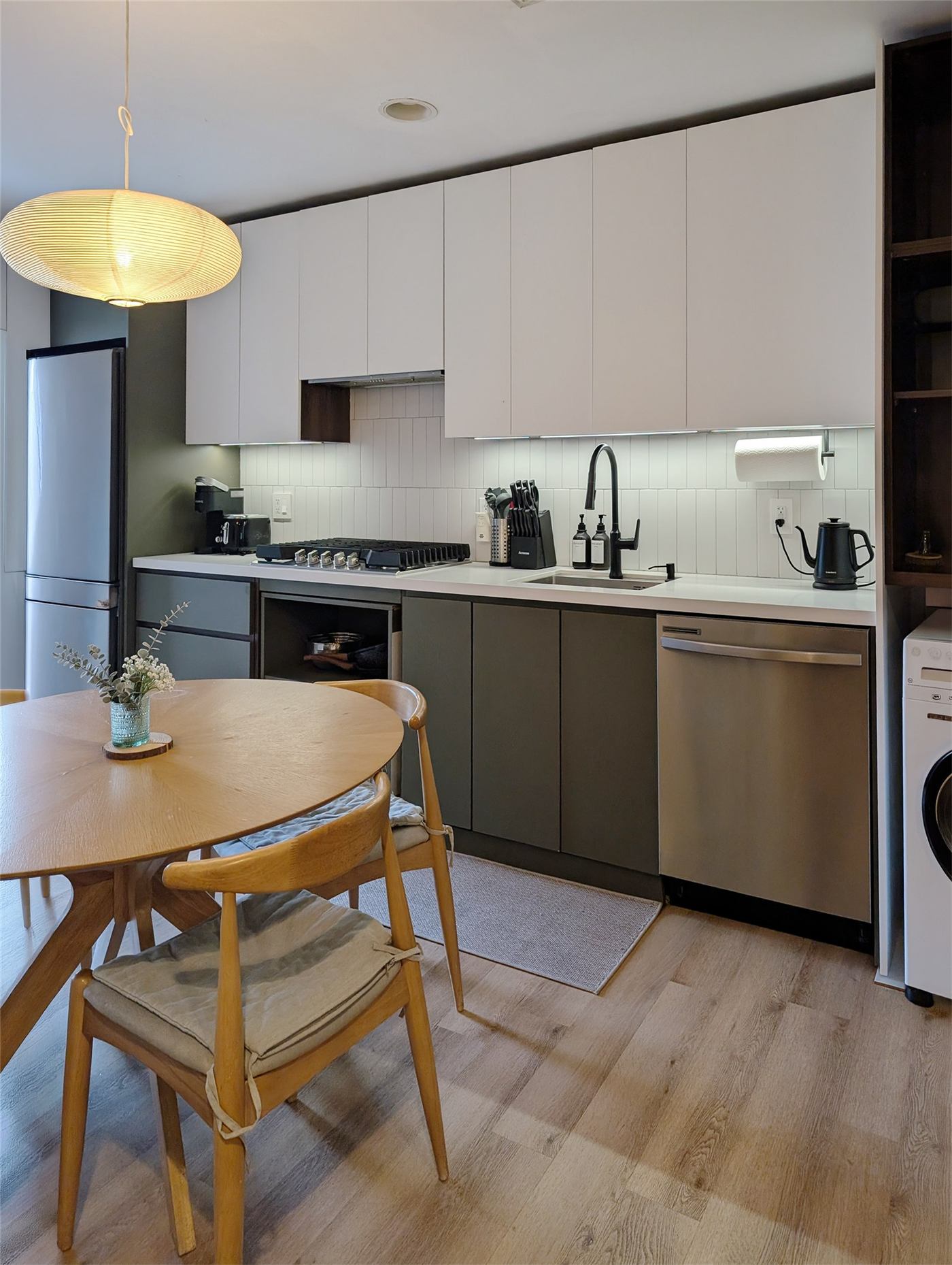 Kitchen No. 1 — green limewash TV wall tying into the kitchen cabinetry