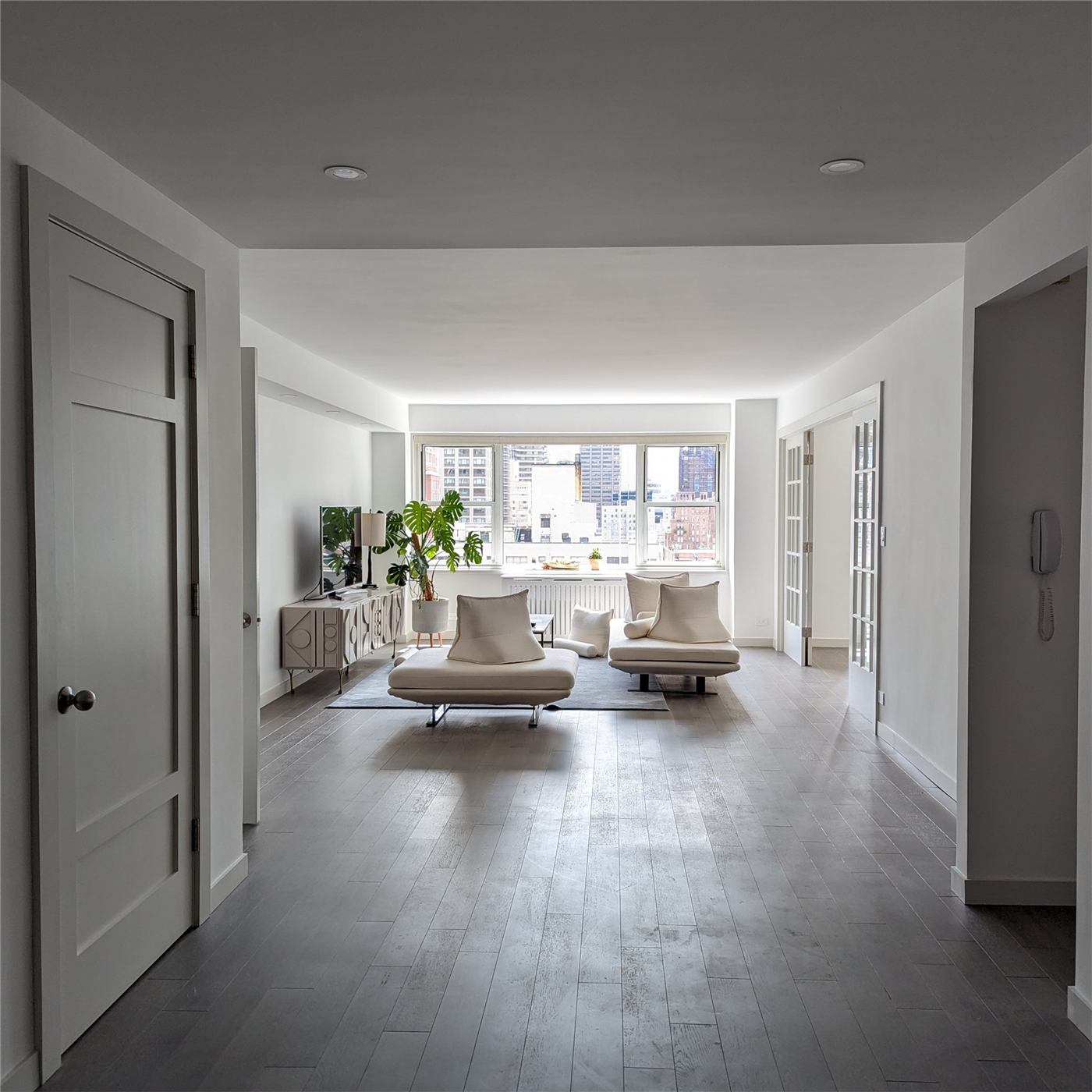 Condo No. 1 — renovated living room in a light neutral palette